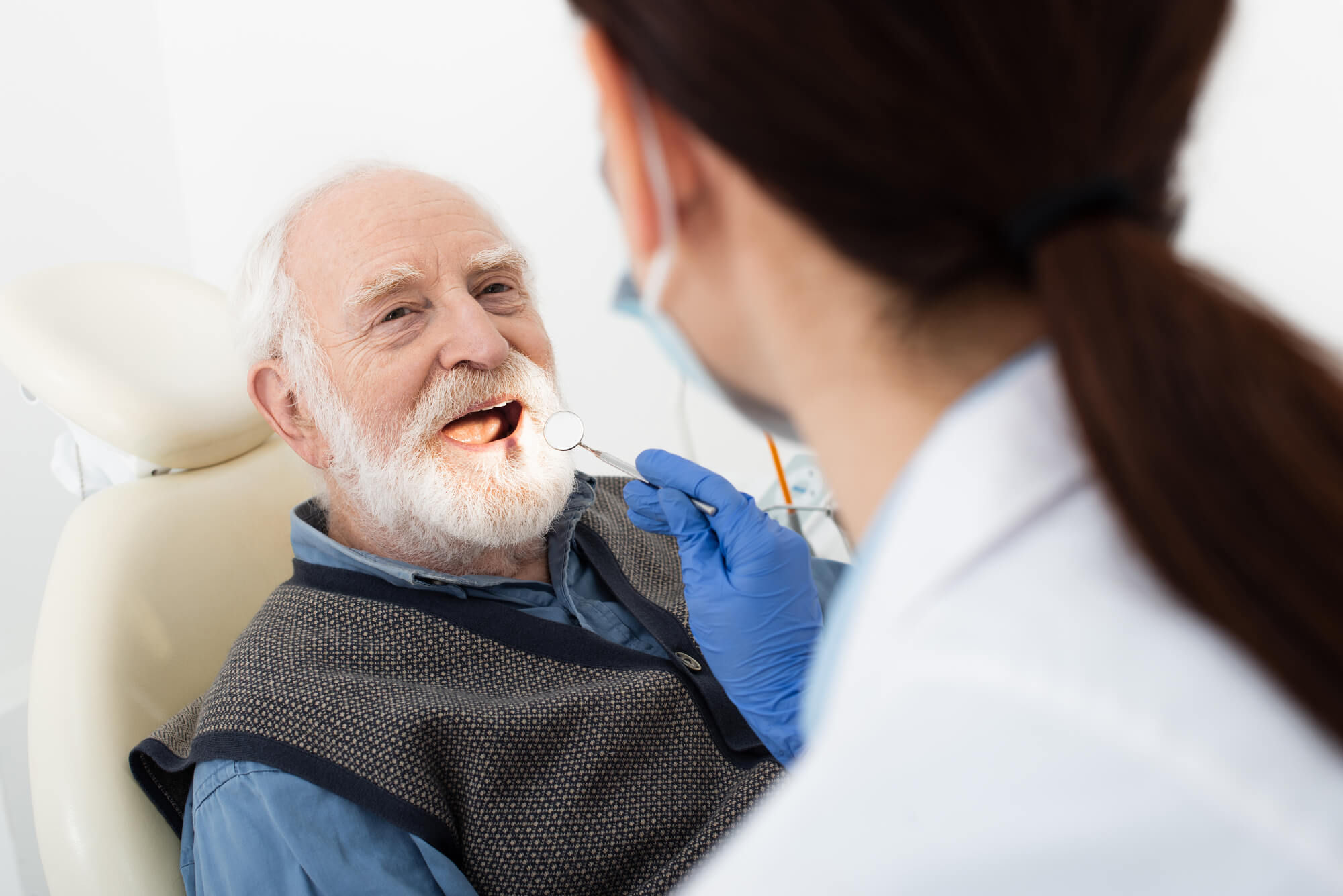 649b18044a99eb1178dab10c an older man smiling before getting Teeth Whitening in Englewood