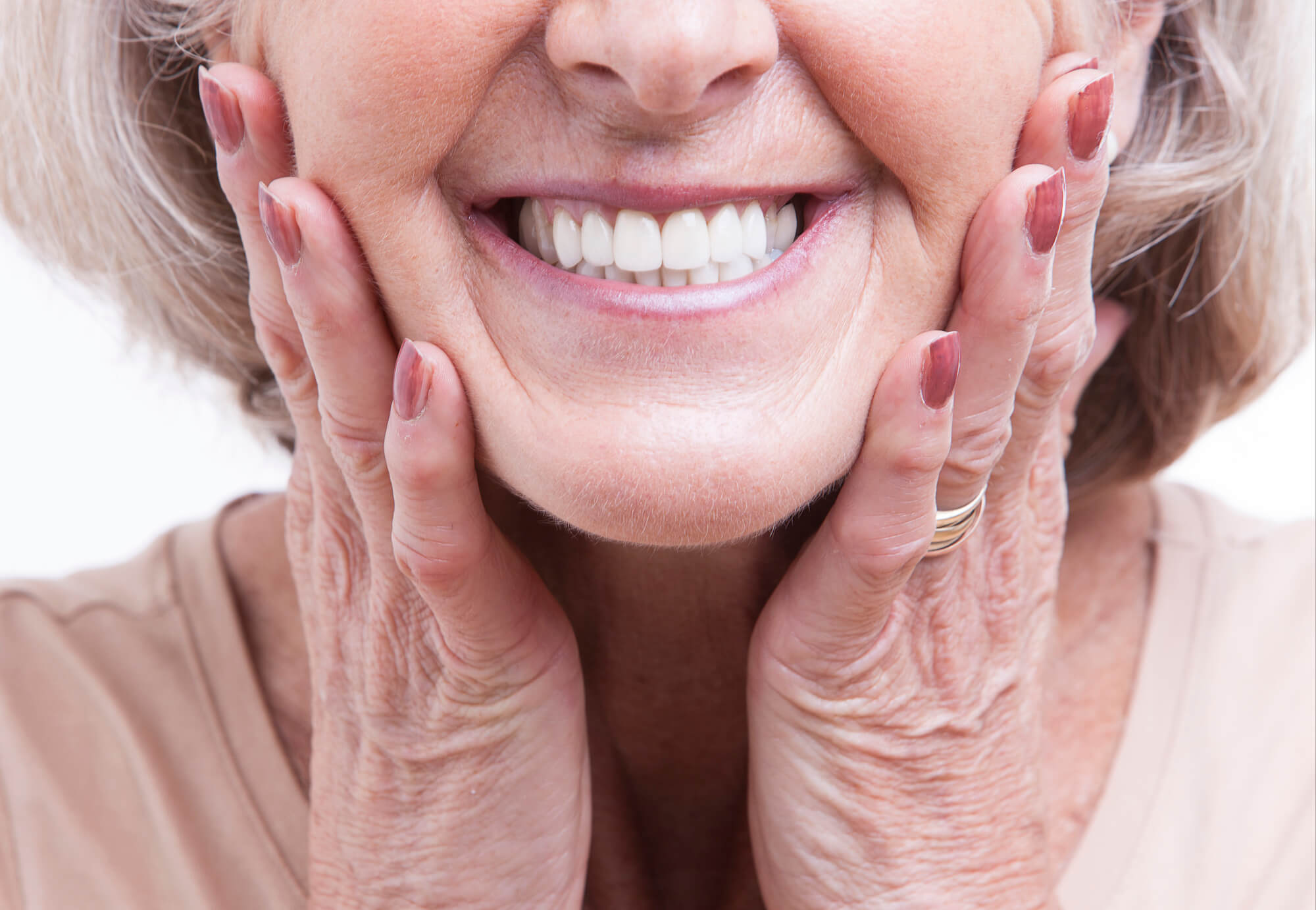 649b18140006a1b9845f45a9 a close up of an older womans bright smile after getting Teeth Whitening in Englewood