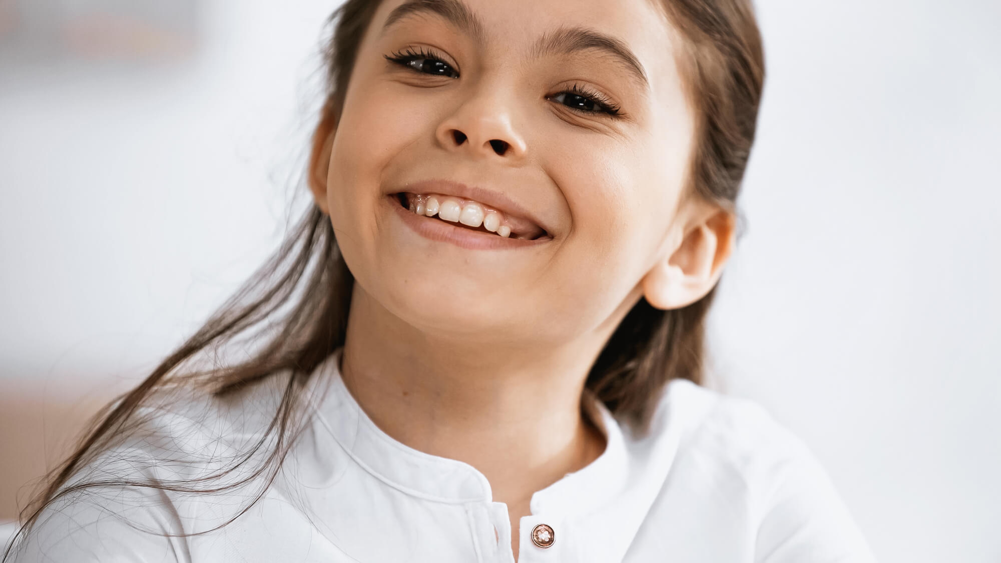 662139212c96c902401314ea a girl smiling after seeing a Family Dentist in Cherry Hills CO 1